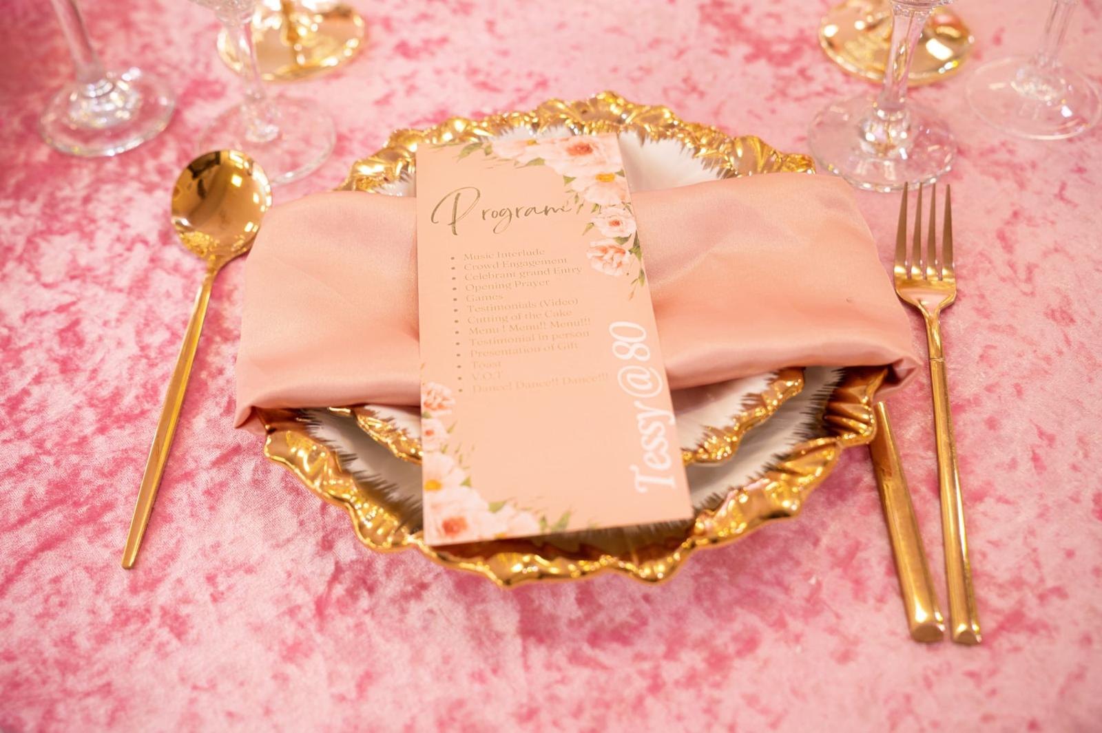 A place setting with a printed menu on a gold charger