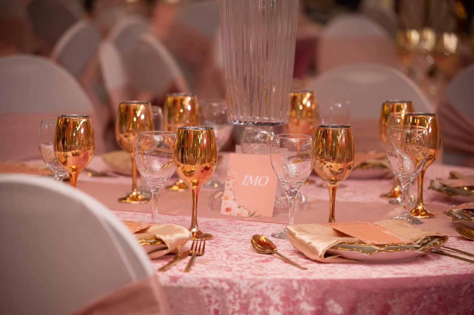 Gold glassware set across a formal table